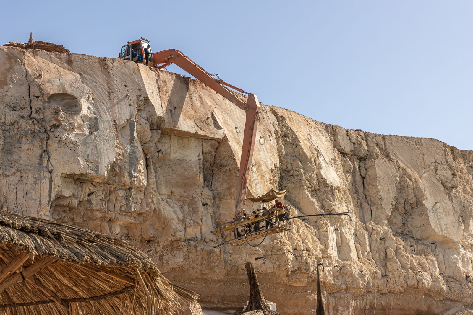 The process of extracting rocks from a cliff in Egypt.